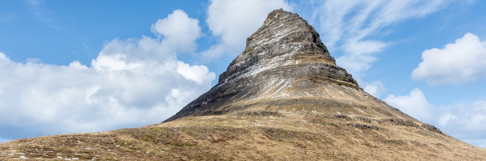 Kirkjufell mountain with blue sky and white clouds